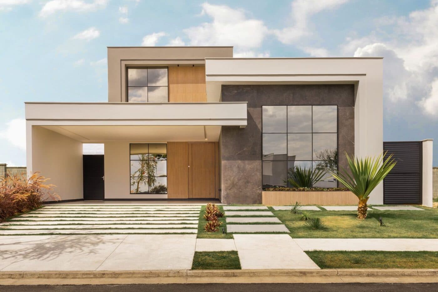 Modern home exterior with large, spotless windows reflecting a bright sky